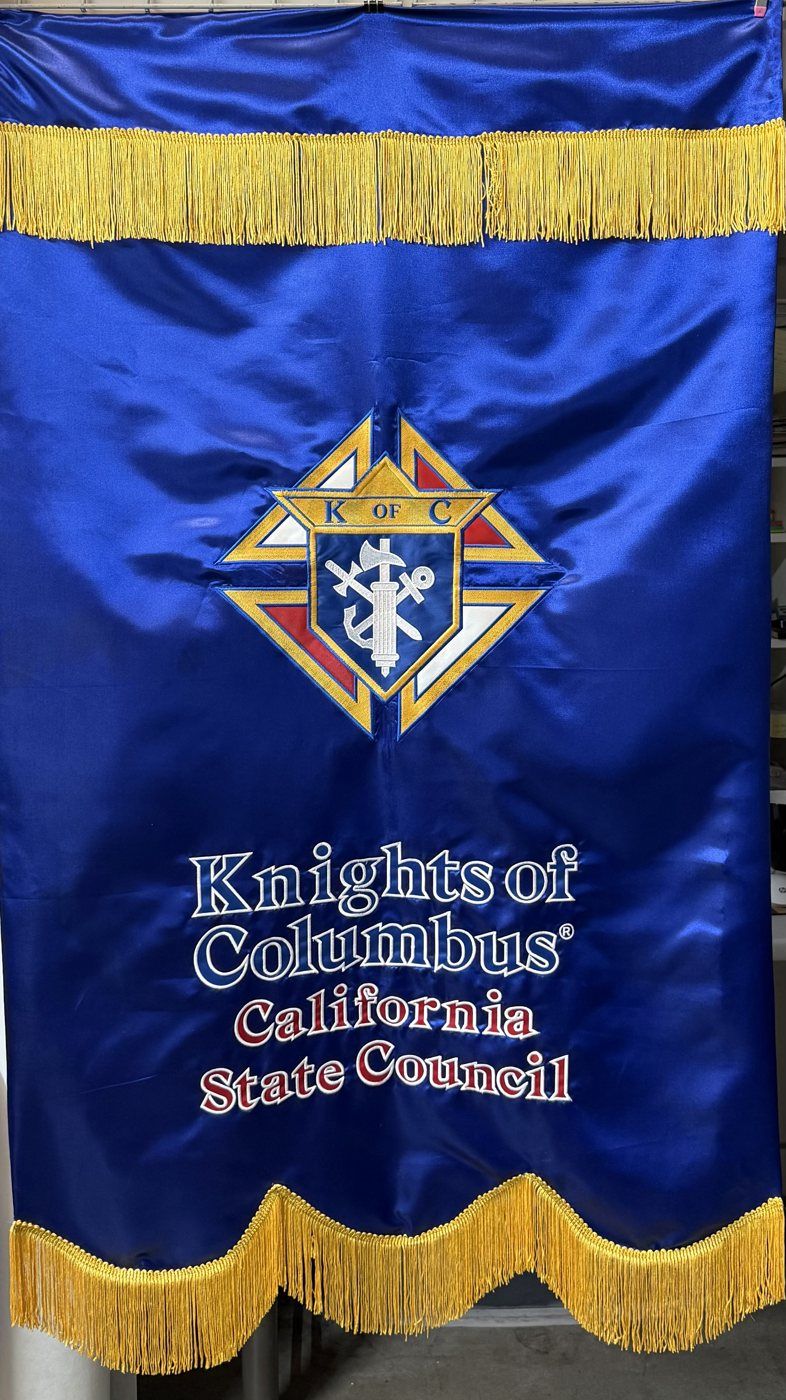 A royal blue satin banner with gold fringe, the Knights of Columbus emblem and the words Knights of Columbus California State Council
